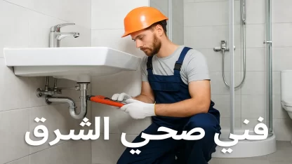 فني صحي الشرق بالكويت يقوم بفحص مواسير المياه داخل حمام حديث باستخدام أدوات سباكة احترافية.